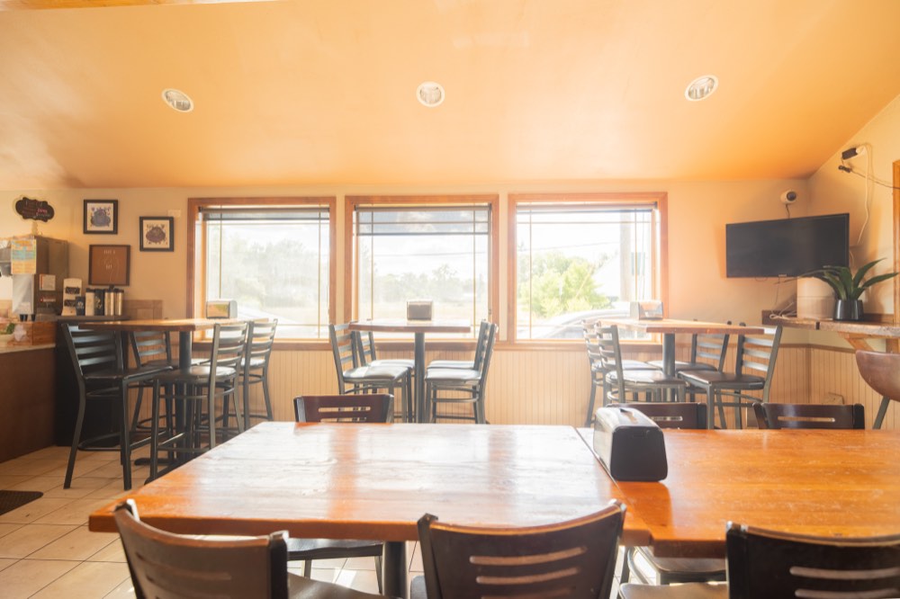 High-top tables along the big bright windows
