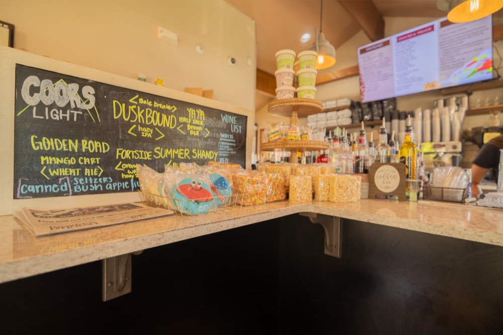 The counter with house-made treats, cookies, and the beer and wine chalkboard