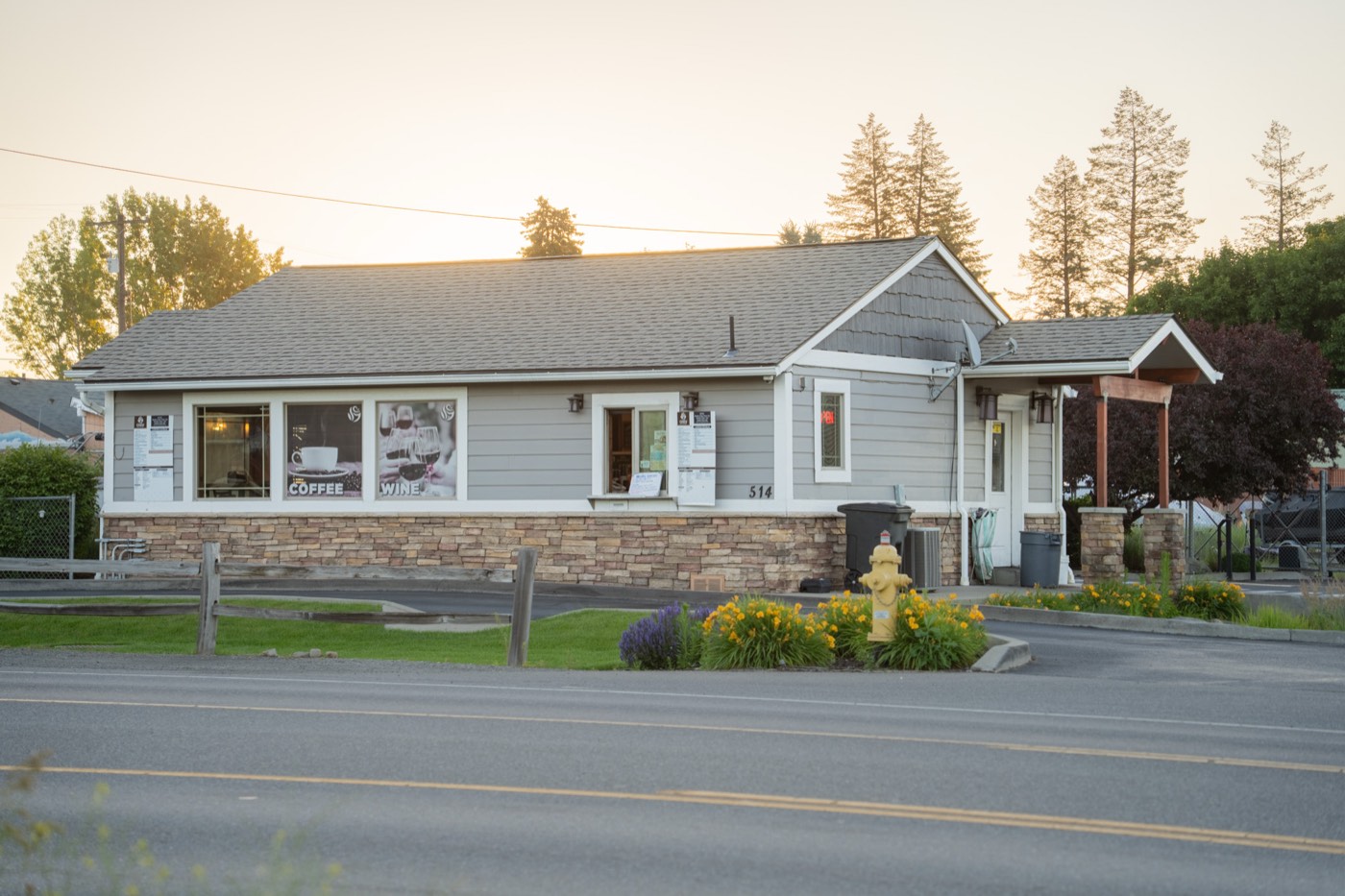 Cozy Coffee and Bistro seen from Barker Road at sunrise, warm glow behind the roofline